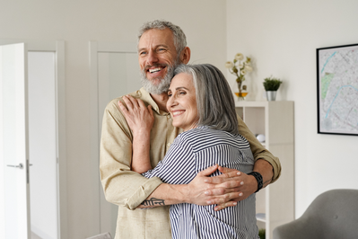 elderly couple hugging