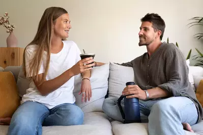 woman and man on couch with detox drinks