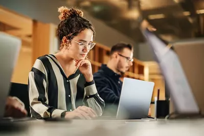 young woman focusing on computer