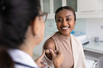 woman getting bandage after flu shot
